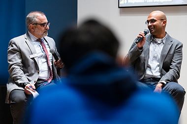 Gregory D. Abowd, Dean of the College of Engineering and Professor of Electrical and Computer Engineering and Anvesh Gurijala, BS 2016 mechanical engineering, sitting on stage presenting at the Young Alumni Impact Award Ceremony.