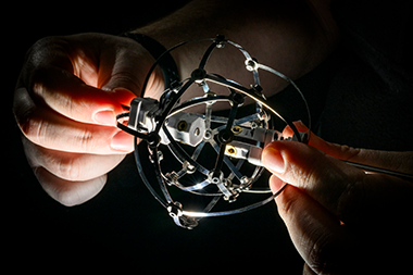 Jeffrey Lipton, assistant professor of mechanical and industrial engineering, holding his robot 
